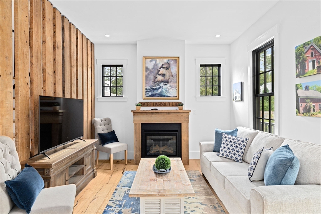 42 Captain Peirce Road Scituate, MA 02066 - Photo 7 of 40 a living room with furniture a flat screen tv and a fireplace