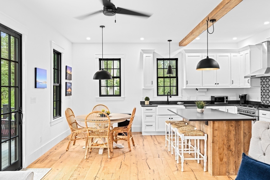 42 Captain Peirce Road Scituate, MA 02066 - Photo 8 of 40 a kitchen with stainless steel appliances granite countertop a stove a sink a dining table and chairs