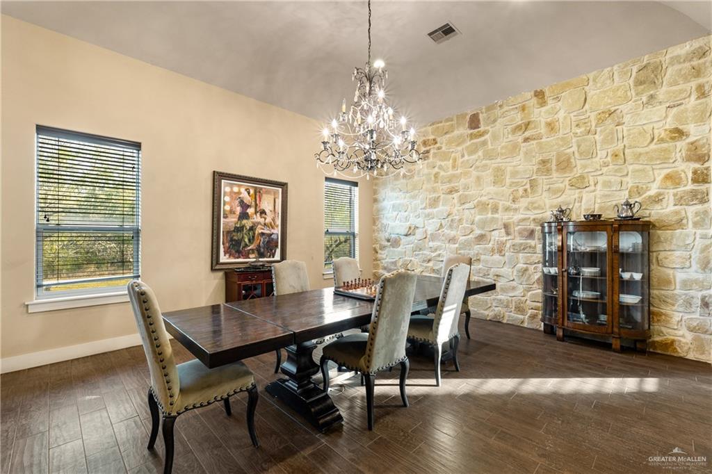 17839 Abd Road Harlingen, TX 78552 - Photo 11 of 38 a view of a dining room with furniture and chandelier