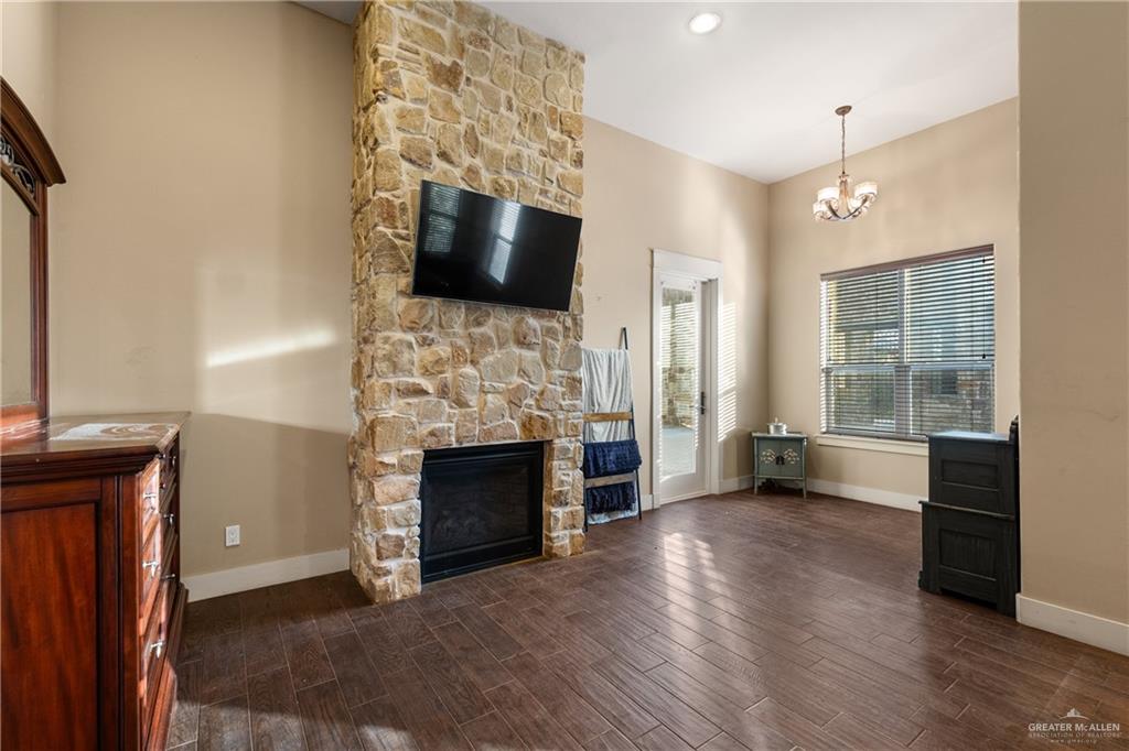 17839 Abd Road Harlingen, TX 78552 - Photo 14 of 38 a view of a livingroom with a fireplace wooden floor and windows