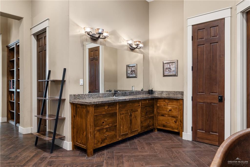17839 Abd Road Harlingen, TX 78552 - Photo 18 of 38 a spacious bathroom with a granite countertop sink a mirror and shower