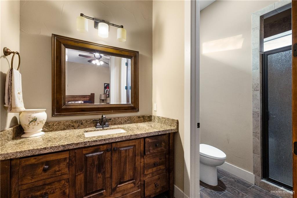 17839 Abd Road Harlingen, TX 78552 - Photo 26 of 38 a bathroom with a granite countertop sink toilet and mirror