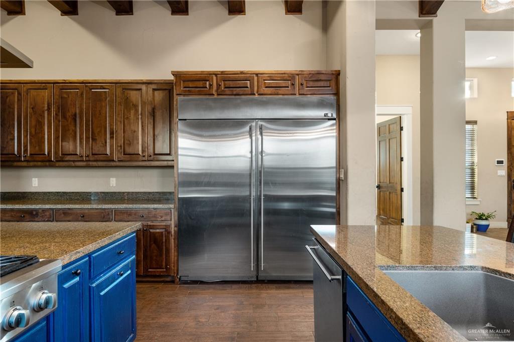 17839 Abd Road Harlingen, TX 78552 - Photo 7 of 38 a kitchen with kitchen island granite countertop a refrigerator and a sink