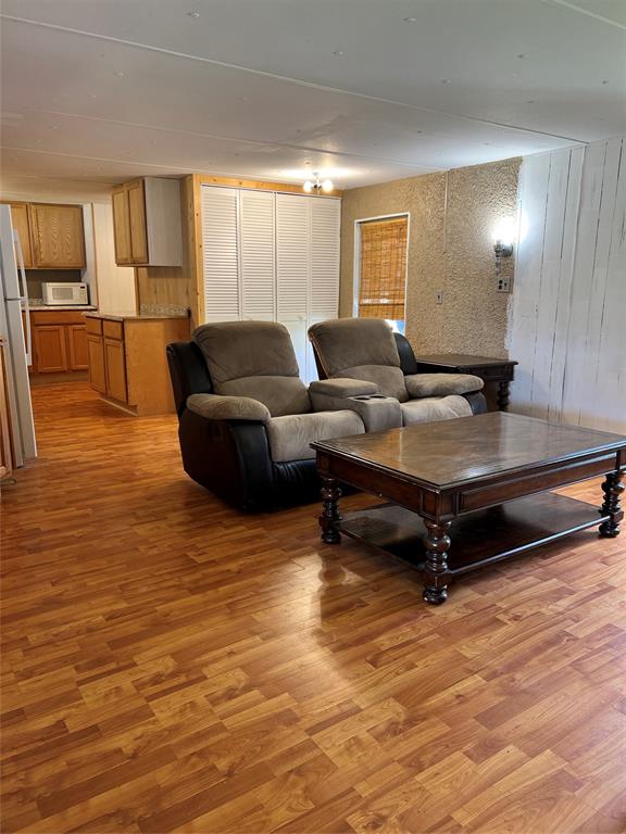 2334 San Bar Road, Unit 46 Graford, TX 76449 - Photo 12 of 37 a living room with furniture and a wooden floor