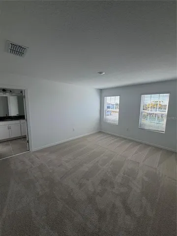 a bathroom with a granite countertop double vanity sink and a mirror