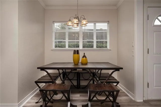 a view of a dining room with furniture and window