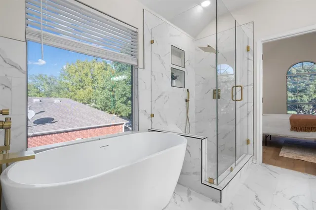 a bathroom with a tub and shower