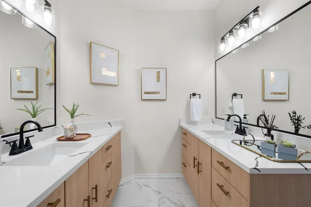 a bathroom with a sink double vanity and a mirror
