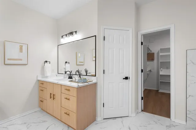 a bathroom with a granite countertop sink a mirror and a