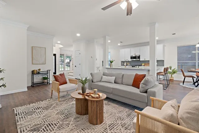 a living room with furniture and a chandelier