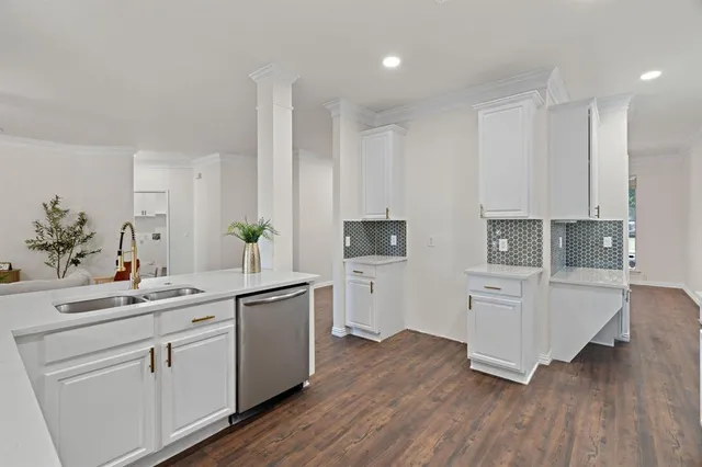 a kitchen with white cabinets and white appliances