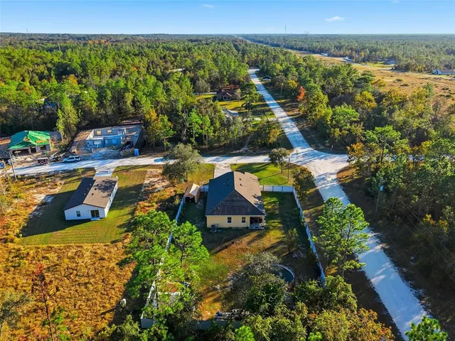 an aerial view of a house with yard swimming pool and outdoor seating