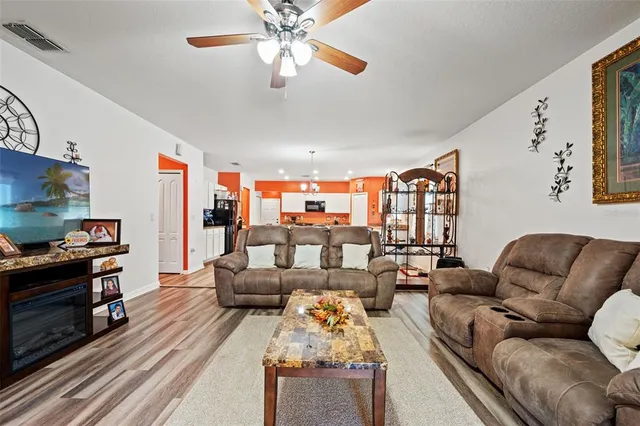 a living room with furniture fireplace and flat screen tv
