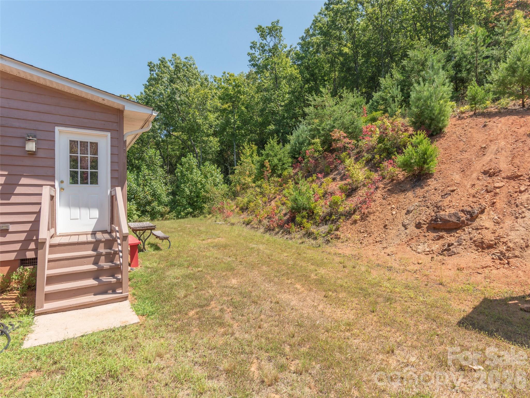 1120 Jacobs Branch Road Franklin, NC 28734 - Photo 31 of 36 a view of a yard with plants and wooden fence