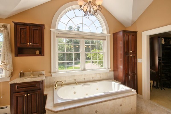 a bathroom with a tub sink and window