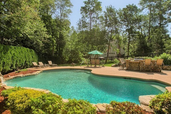 84 Sunset Rock Road Andover, MA 01810 - Photo 30 of 30 a view of a swimming pool with lawn chairs and plants