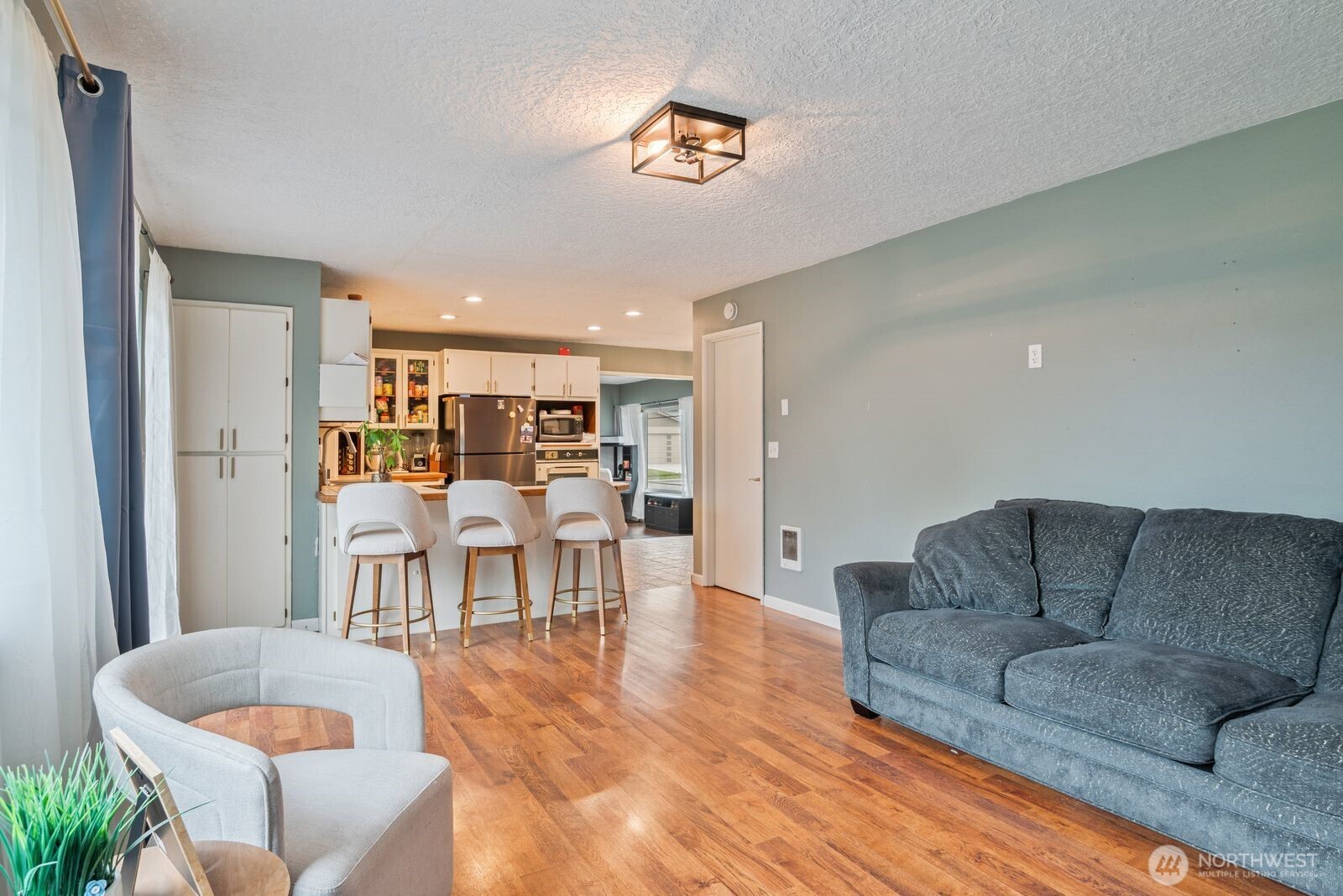 2244 Lee Avenue Longview, WA 98632 - Photo 14 of 27 a living room with furniture and a dining table with kitchen view