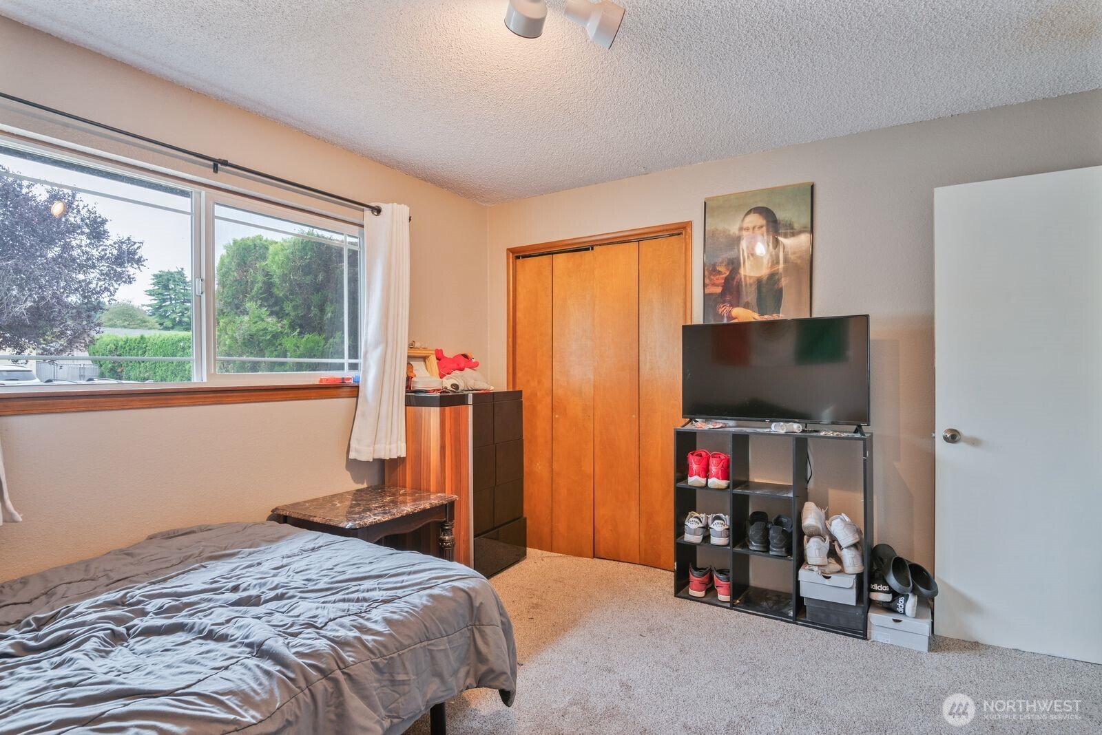 2244 Lee Avenue Longview, WA 98632 - Photo 22 of 27 a bedroom with a bed and a flat tv screen next to a window
