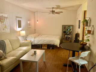 Bedroom featuring a textured ceiling, wood finished floors, and ceiling fan