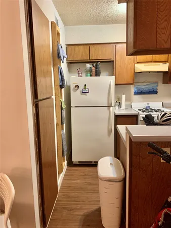 a white refrigerator freezer sitting inside of a kitchen