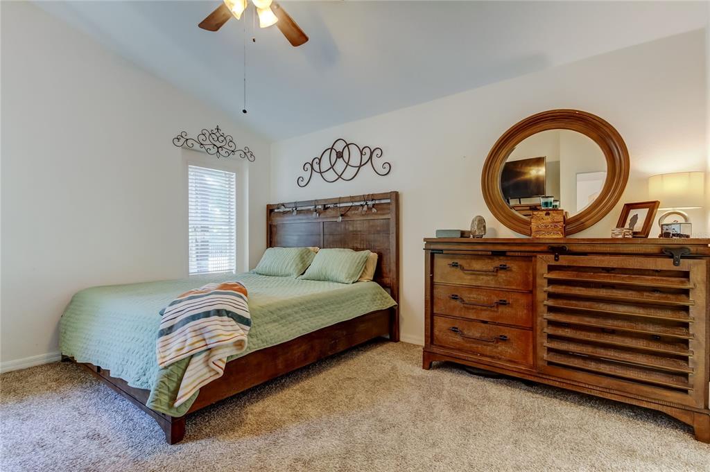 4522 Lisette Circle Brooksville, FL 34604 - Photo 28 of 59 a bedroom with a bed and a chandelier