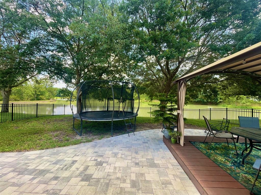 4522 Lisette Circle Brooksville, FL 34604 - Photo 3 of 59 a view of a backyard with sitting area and garden