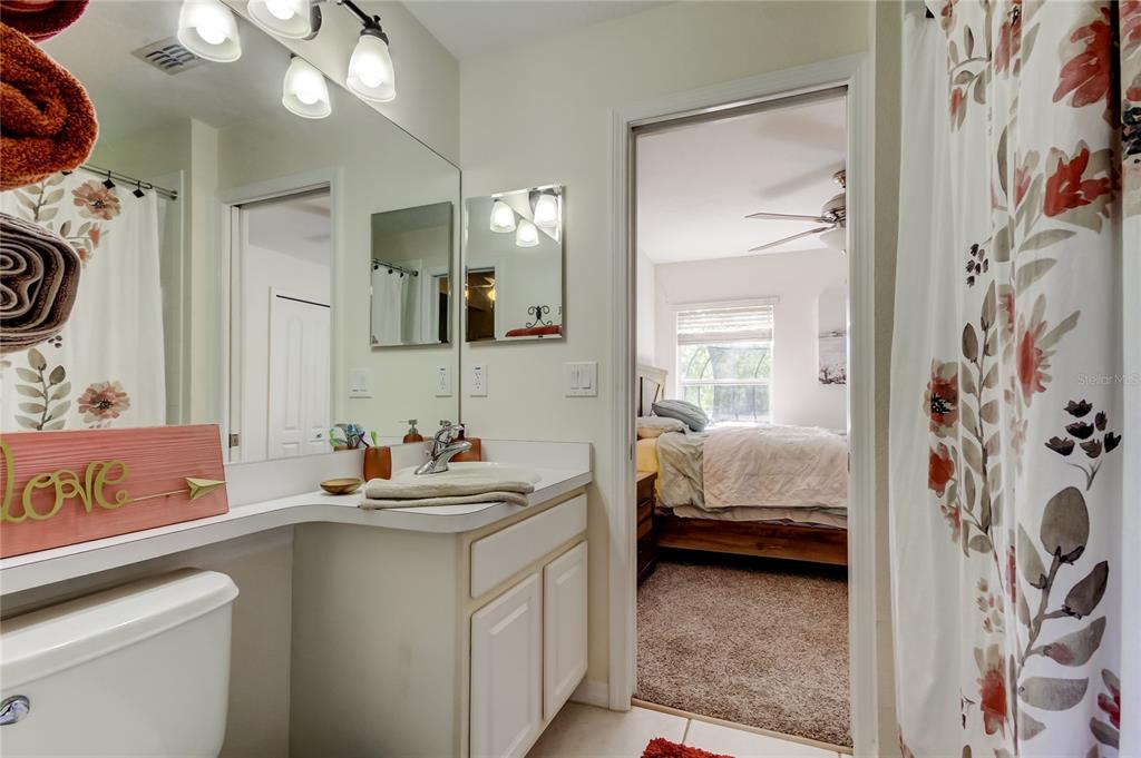 4522 Lisette Circle Brooksville, FL 34604 - Photo 36 of 59 a en suite bathroom with a sink a mirror and a shower