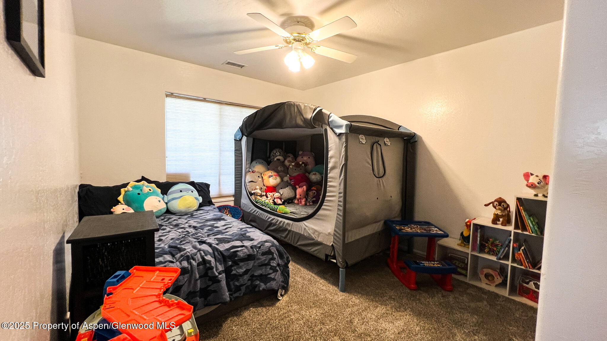 786 Comstock Drive Fruita, CO 81521 - Photo 26 of 38 a bedroom with bed and a chandelier