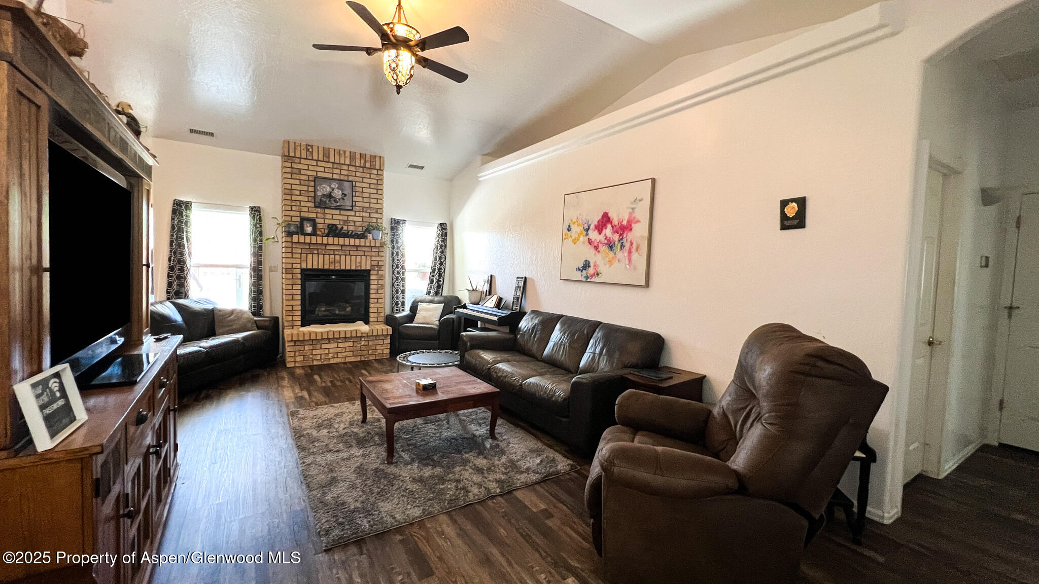 786 Comstock Drive Fruita, CO 81521 - Photo 6 of 38 a living room with furniture and a fireplace