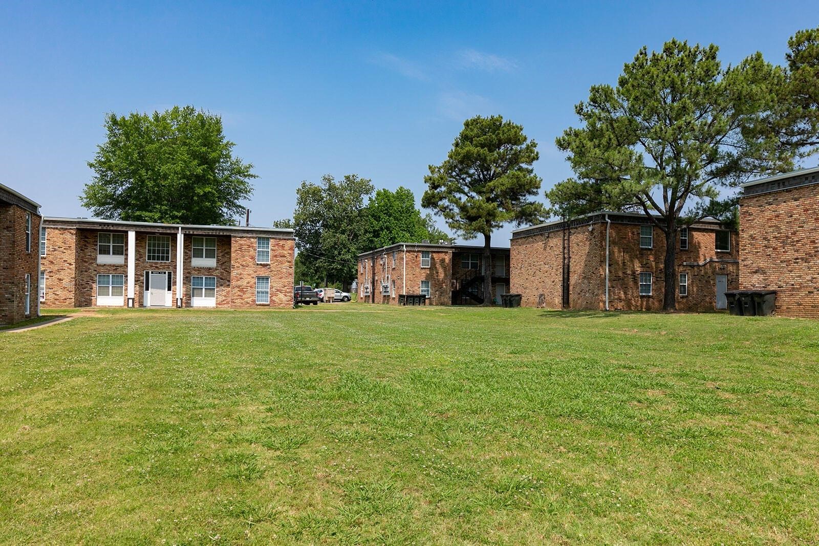 3236 Millington Road Memphis, TN 38127 - Photo 22 of 31 Expansive green space surrounded by brick apartment buildings