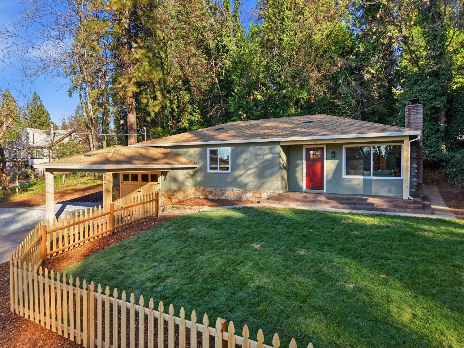 a view of a house with backyard and sitting area