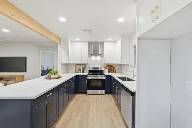 a kitchen with a sink stove and cabinets