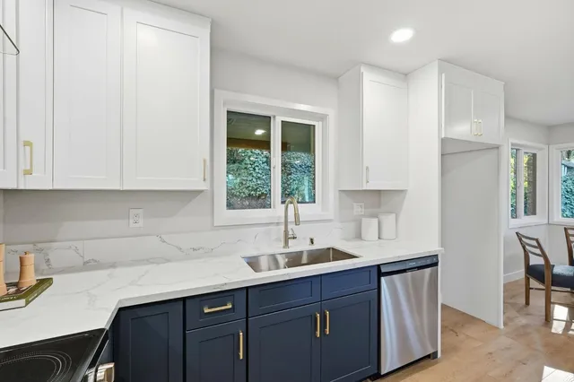 a kitchen with a sink cabinets and window