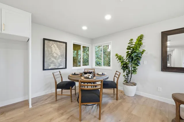 a dining room with furniture and window