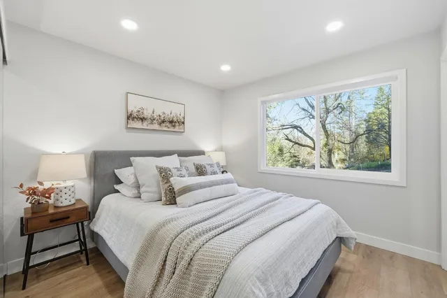 a bedroom with a bed and a painting on the wall