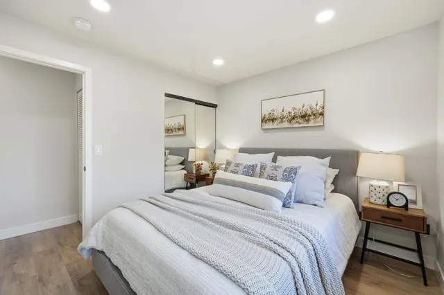 a bedroom with a bed and a painting on the wall