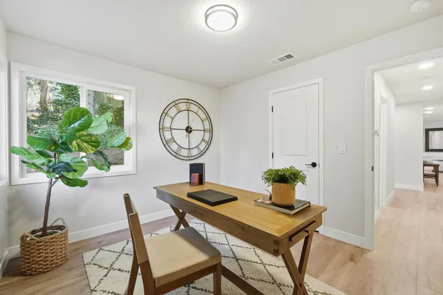 a view of a dining room with furniture and wooden floor