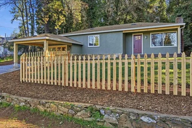 a front view of a house with a garden