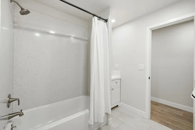 a bathroom with a bathtub and a shower