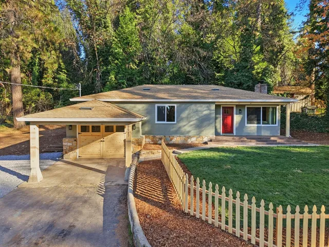 a view of a house with backyard and sitting area