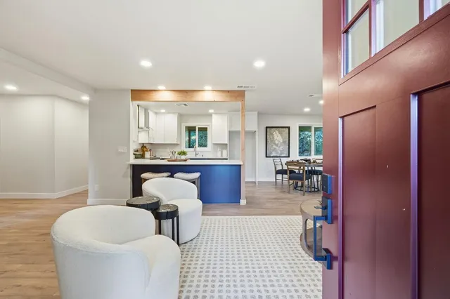 a kitchen with a sink cabinets and living room view