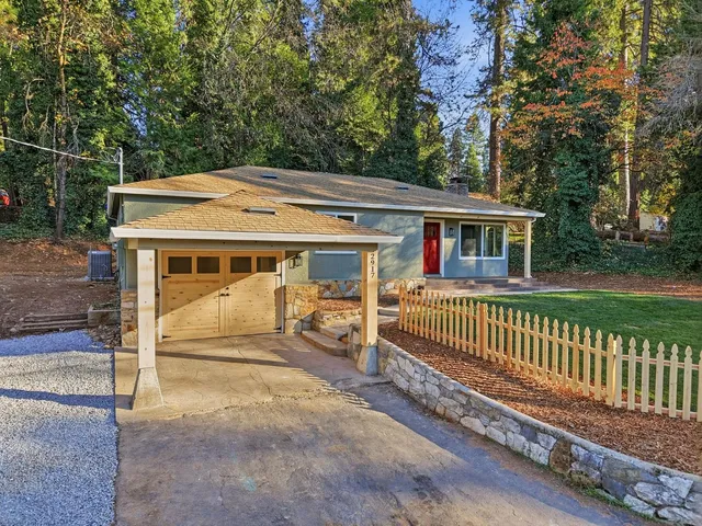 a front view of a house with a garden