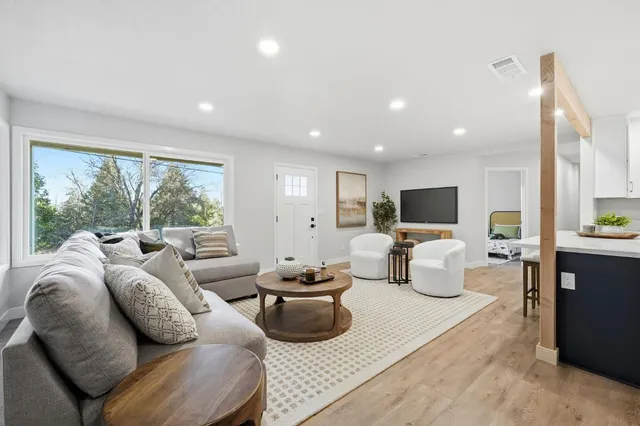 a living room with furniture and a large window
