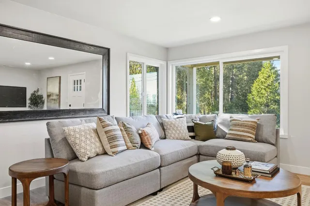 a living room with furniture and a large window