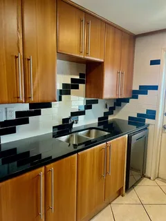 a bathroom with a granite countertop sink a toilet and bathtub