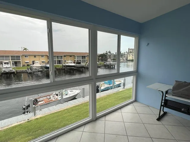 a view of a house with yard and sitting area