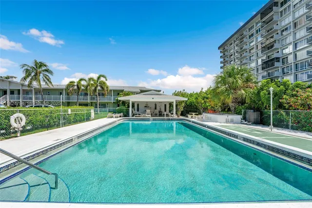 a view of a patio with swimming pool table and chairs