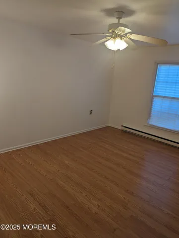 wooden floor in an empty room with a window