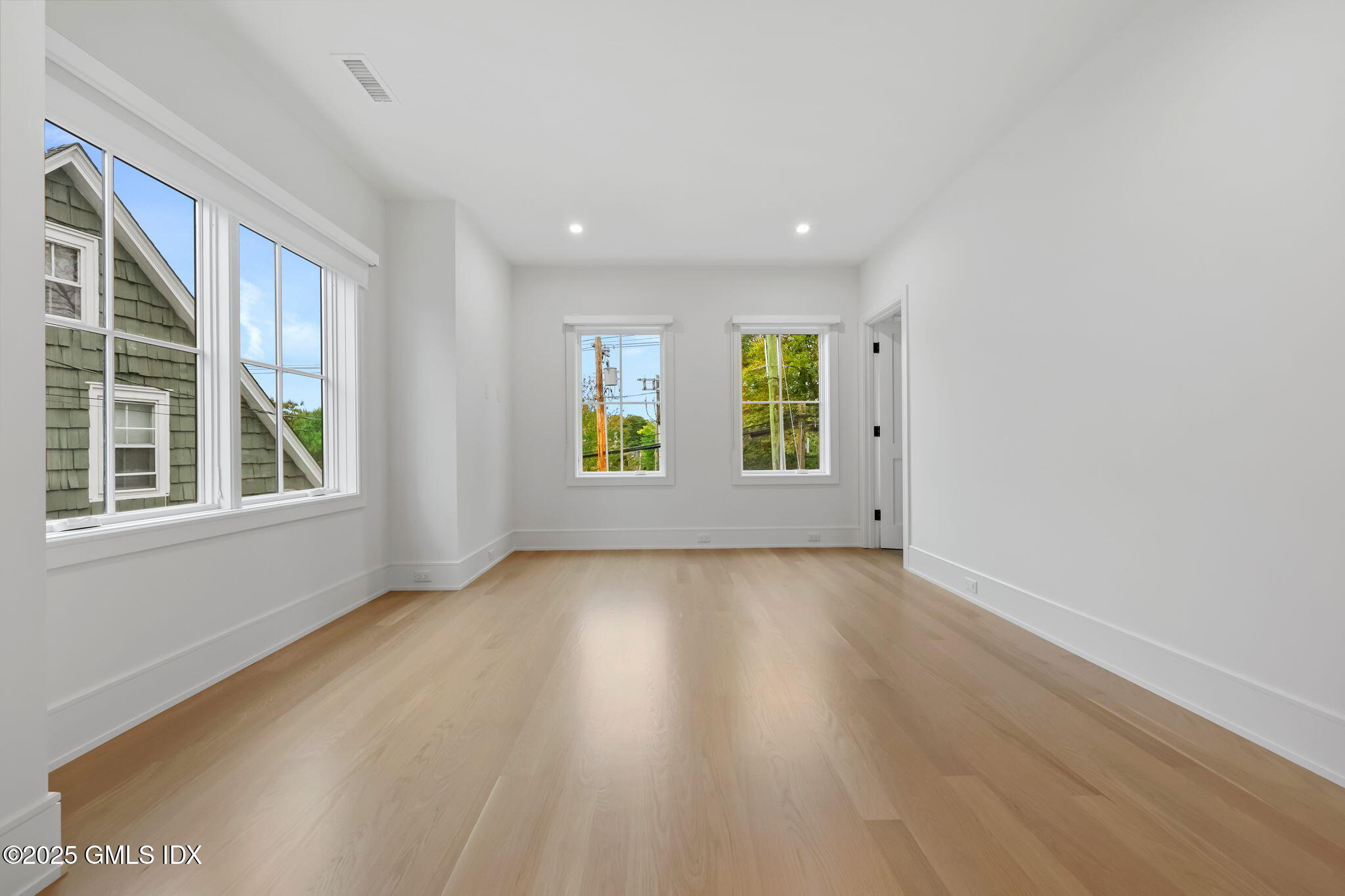 187 Field Point Road, Unit B Greenwich, CT 06830 - Photo 16 of 32 a view of an empty room with a window and wooden floor