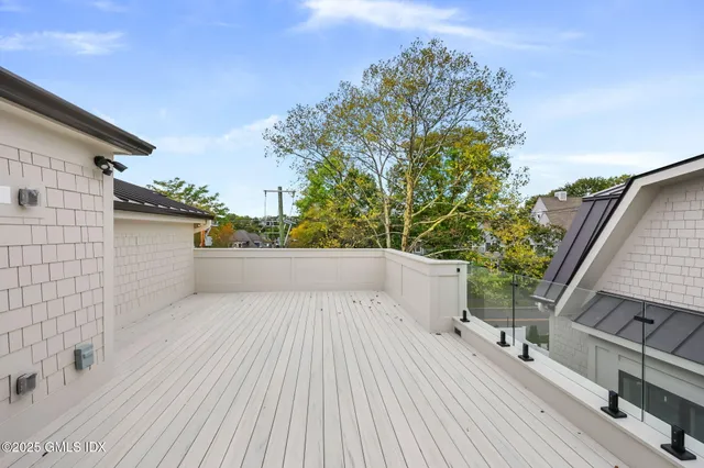 a view of balcony with wooden floor and fence